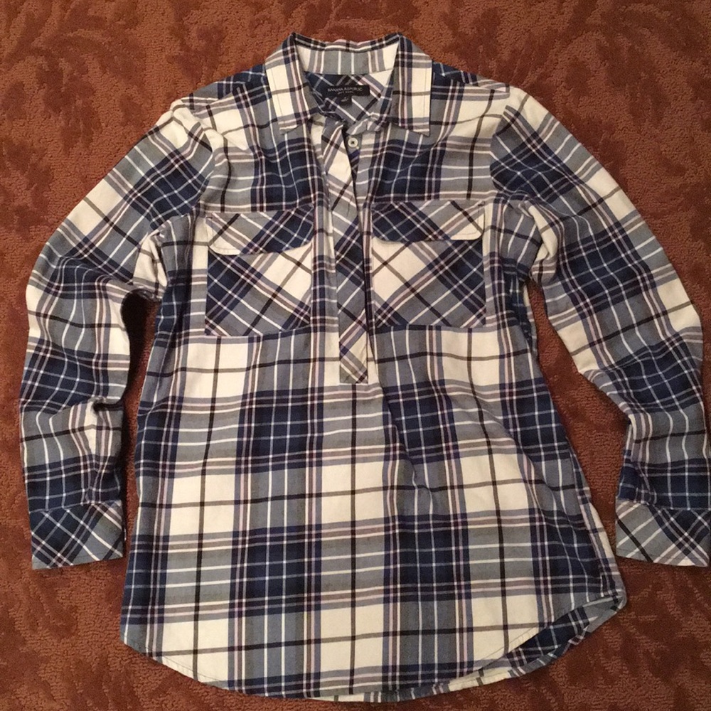 Plaid shirt buttons half way down front.